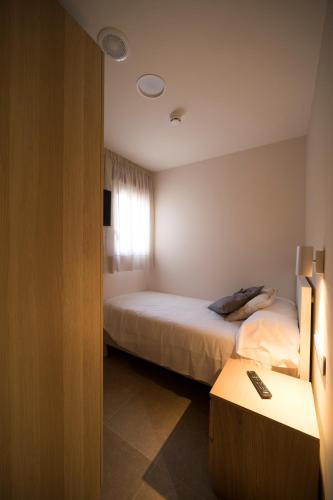 a hotel room with two beds and a window at Hostal Martínez in Villafranca