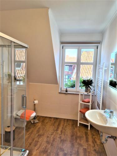 a bathroom with a sink and a shower at Ferienwohnungen Burgfried in Wernigerode