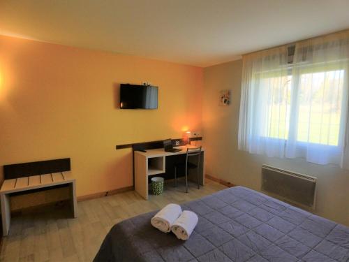 a bedroom with a bed and a tv on the wall at Hôtel Azur Saint Junien Cit'Hotel in Saint-Junien