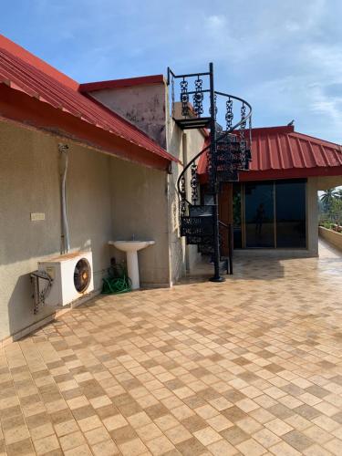 a patio with a building with a fire escape at Boloors sea la vie in Suratakal