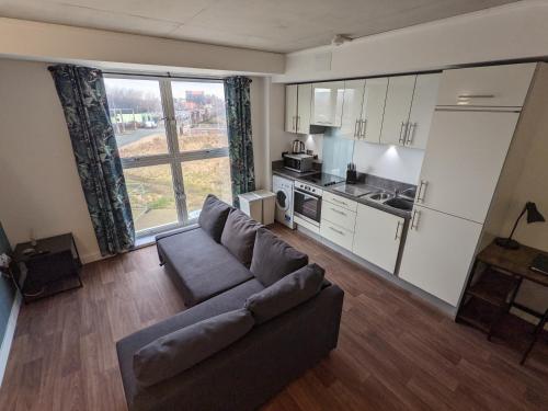 a living room with a couch and a kitchen at Middlehaven Studio in Middlesbrough