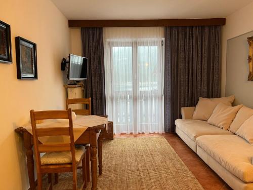 a living room with a couch and a table at Ferienwohnungen Reiteralpe in Ramsau