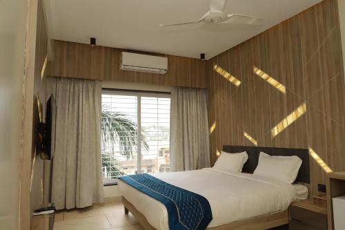 a bedroom with a large bed and a window at Hotel Florence in Nānded