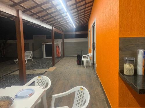 a room with a table and chairs in a room at Faith Home 2 in Arraial do Cabo