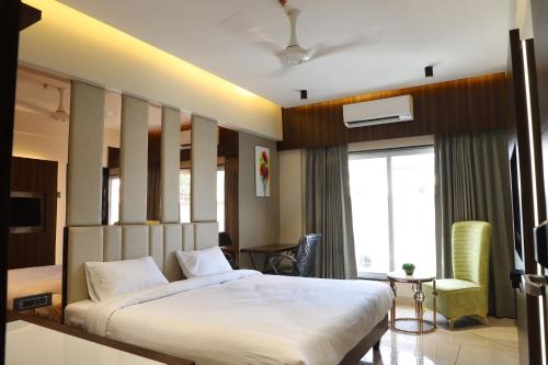 a bedroom with a large bed and a window at Hotel Florence in Nānded