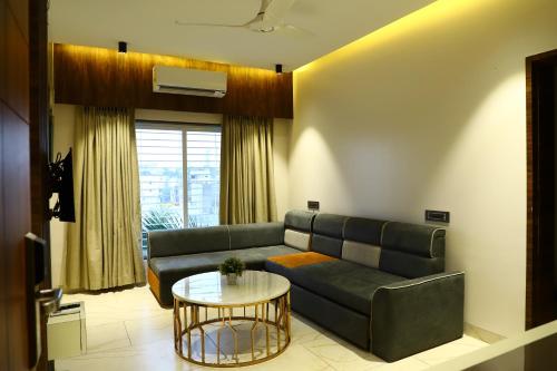 a living room with a couch and a table at Hotel Florence in Nānded