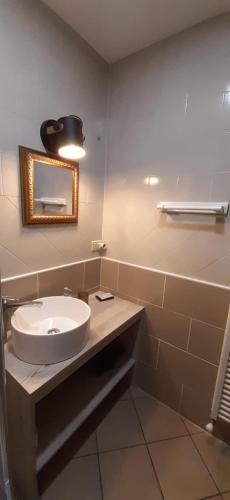 a bathroom with a sink and a mirror at Hotel Residence Giardini in Piode