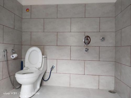 a bathroom with a toilet and a shower at LA-TSAS GUEST HOUSE in Hundar