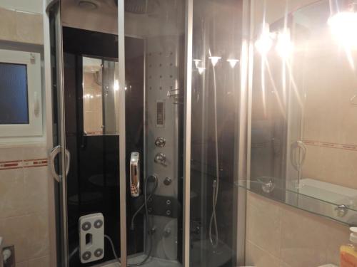 a shower with a glass door in a bathroom at Apartment in Povlja with sea view, terrace, air conditioning, WiFi 3419-1 in Povlja