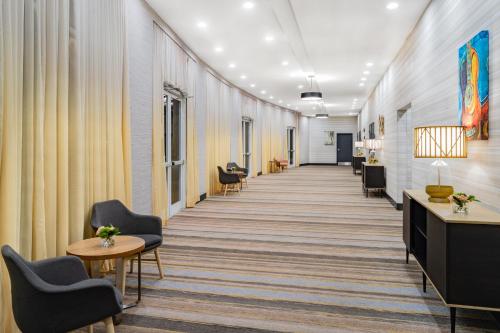 a corridor of an office with chairs and tables at Holiday Inn Southaven Central - Memphis by IHG in Southaven