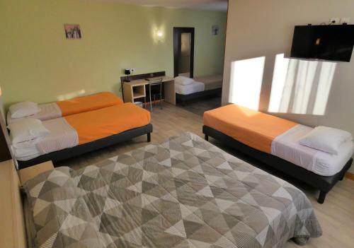 a hotel room with two beds and a desk at Hôtel Azur Saint Junien Cit'Hotel in Saint-Junien