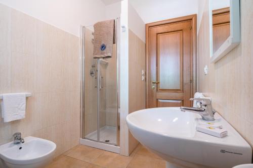 a bathroom with a sink and a shower at Club del Sole Stork Family Collection in Giulianova