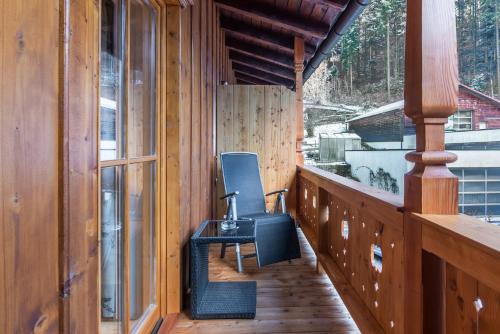 a chair on the porch of a cabin at Gasthaus Posch in Miesbach