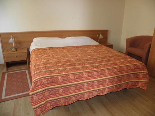 a bedroom with a large bed with a blanket on it at Apartment in Premantura with terrace, air conditioning, WiFi, washing machine 3352-27 in Premantura