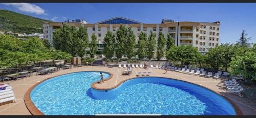 a large swimming pool in front of a building at Gran Paradiso Hotel Spa in San Giovanni Rotondo