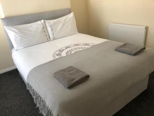 uma cama grande com duas almofadas em cima em Hinton House em Liverpool