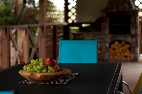 a bowl of fruit sitting on top of a table at Dadajowa Osada - Dadaj in Biskupiec