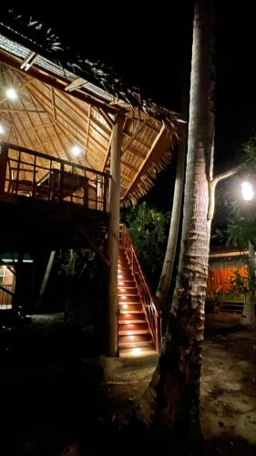 a staircase leading up to a building at night at Nyande Raja Ampat in Pulau Mansuar