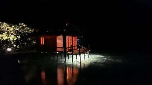 a small cabin at night with red lights at Nyande Raja Ampat in Pulau Mansuar