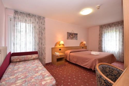 Postel nebo postele na pokoji v ubytování Hotel Villa Agomer