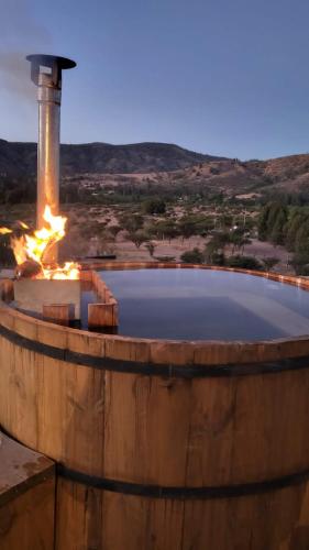 a large wooden barrel with a fire in it at CABAÑA DE CAMPO in Cuncumén