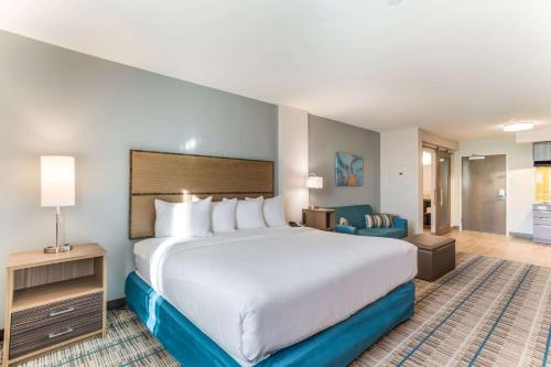 a hotel room with a large bed and a chair at MainStay Suites Murfreesboro in Murfreesboro