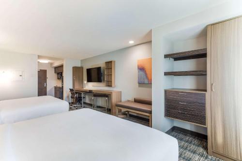 a hotel room with two beds and a desk at MainStay Suites Murfreesboro in Murfreesboro