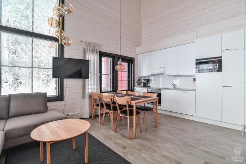 a kitchen and living room with a table and chairs at Holiday in Lapland - SointuiLevi A71 in Levi
