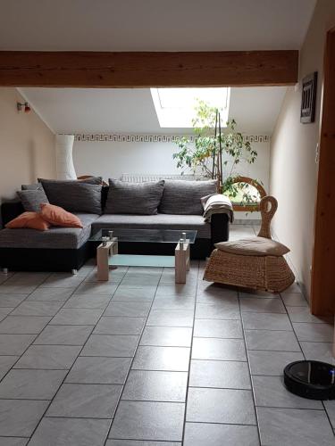 a living room with a couch and a window at Am Valtlhof in Grabenstätt