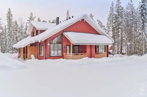 a red cabin in the snow with trees at Holiday in Lapland - SointuiLevi A71 in Levi