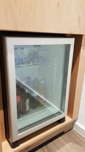 a refrigerator filled with bottles of water and food at Cross-Country-Hotel Hirsch in Sinsheim