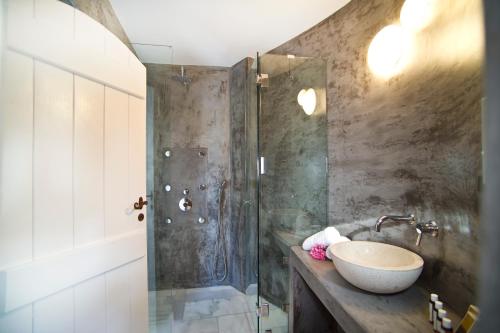 a bathroom with a sink and a shower at Avista Suites in Imerovigli