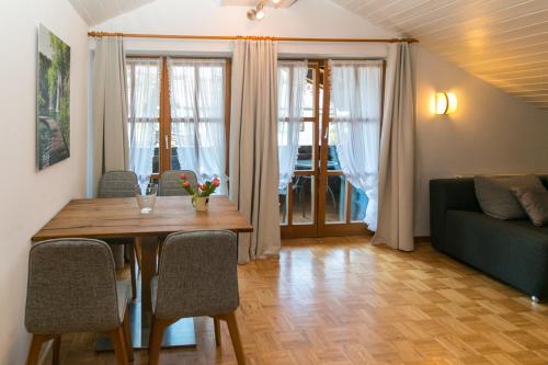a living room with a table and a couch at Haus Sonnenrose in Reit im Winkl
