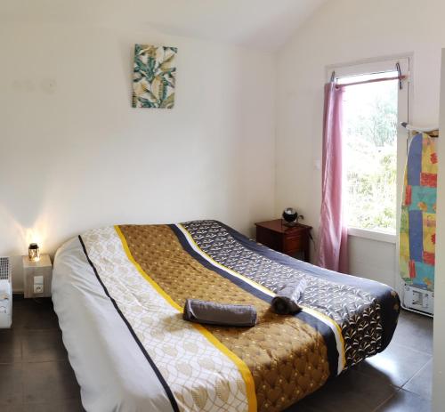 a bedroom with a bed with a suitcase on it at Villa Camélias in La Plaine des Palmistes