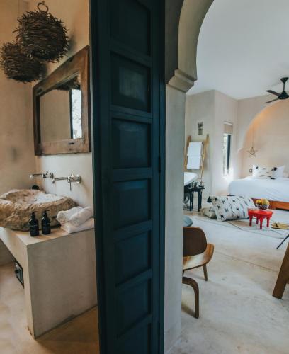 a room with a door leading to a bedroom at Ambre & Epices Jungle Hotel & Spa in Tulum