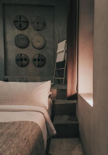 a bedroom with a bed and a staircase with a ladder at Ambre & Epices Jungle Hotel & Spa in Tulum