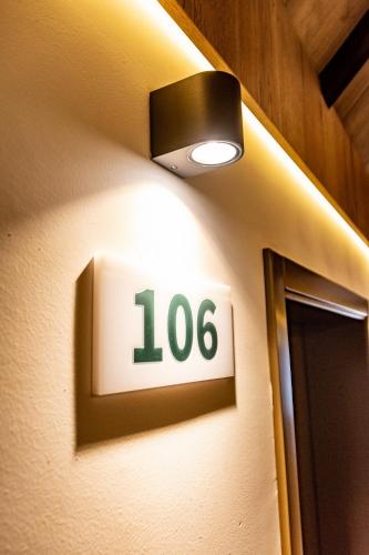 a sign on a wall with the number on it at Hotel Forest in Pale