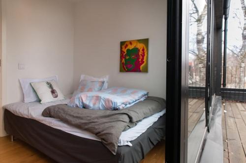 a bed in a room with a window at townhouse on Arlanda Stockholm metro line - easy checkin in Sollentuna