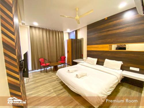 1 dormitorio con 1 cama grande y sillas rojas en Villa Flamingo By 29bungalow, en Udaipur