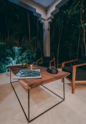 a coffee table with a mouse on top of it at Ambre & Epices Jungle Hotel & Spa in Tulum