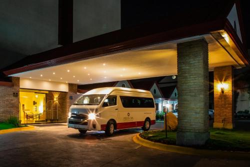 a white van parked in a garage at night at Fiesta Inn Tampico in Tampico