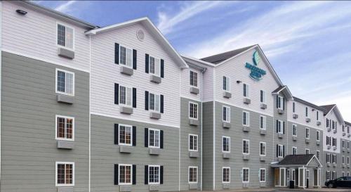 a large building with a clock on the side of it at WoodSpring Suites Brownsville in Brownsville