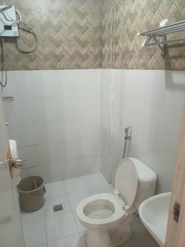 a bathroom with a toilet and a sink at DJCI Apartelle Walk to Robinson & NE Pacific Mall 3 Min to SM Cabanatuan in Cabanatuan