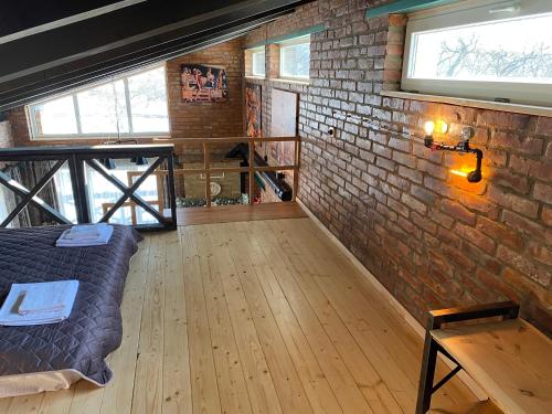 a room with a bed and a brick wall at BrickWood in Verkhniy Koropets