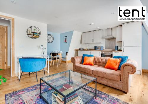 チャーツィーにあるBright, Stylish Two Bedroom Apt in Town Centre with Free Parking at Tent Serviced Apartments Chertseyのソファとテーブルのあるリビングルーム