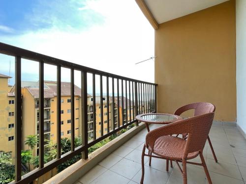 a balcony with a table and chairs and a view of a building at Gold Coast Morib Studio l Apartment I Penthouse in Banting