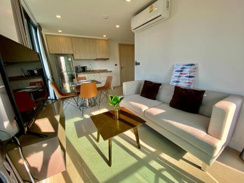 a living room with a couch and a table at Sea Zen Condominium Bang Saray in Bang Sare