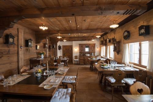 a restaurant with wooden walls and tables and chairs at Landgasthof Ruedihus in Kandersteg