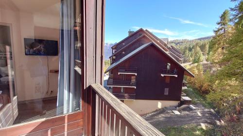 a balcony with a view of a house at Residence Les Ecrins in Puy-Saint-Vincent