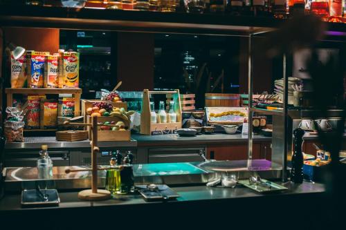 a kitchen with a sink and a counter with food at Me and All Hotel Dusseldorf, by Hyatt in Düsseldorf